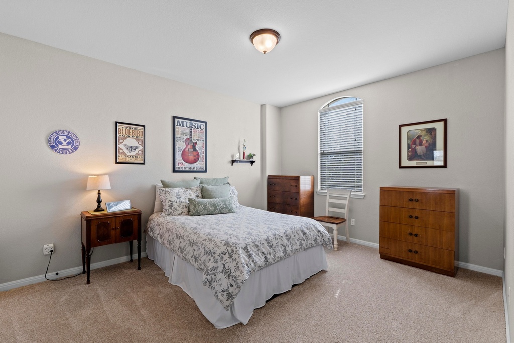 15104 Spillman Ranch Loop Austin, TX 78738 - Photo 20 of 31 a bedroom with a bed and a desk