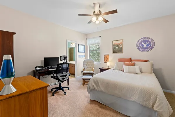 a bedroom with a bed and a desk