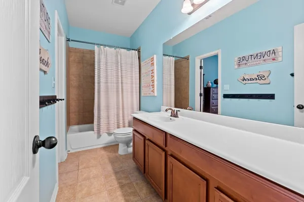 a bathroom with a double vanity sink toilet and shower