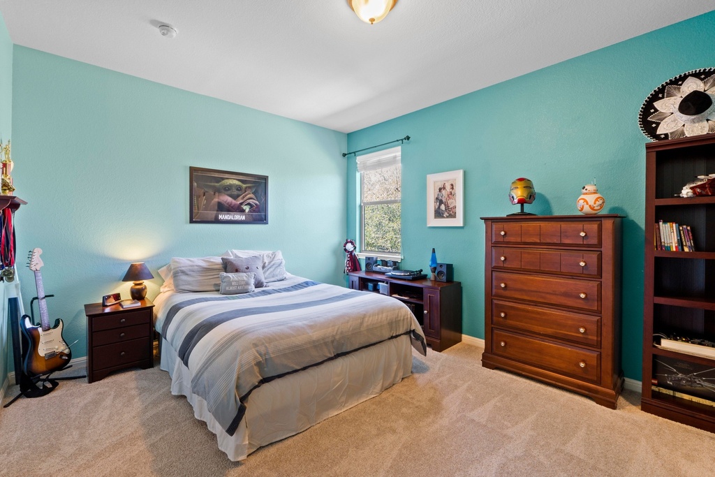 15104 Spillman Ranch Loop Austin, TX 78738 - Photo 24 of 31 a bedroom with a bed and a closet