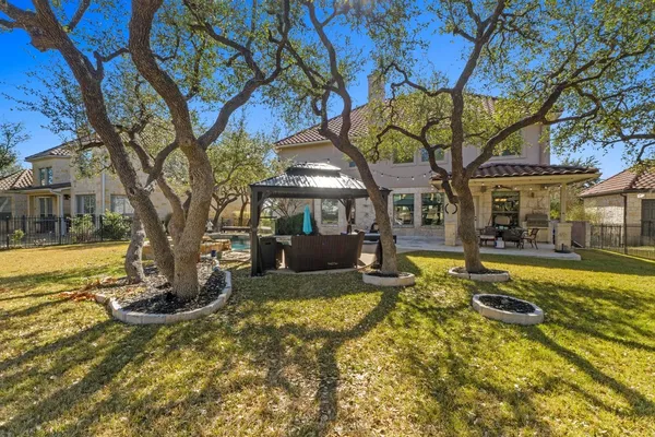 a view of a house with swimming pool and sitting area
