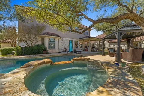 a swimming pool with outdoor seating and yard