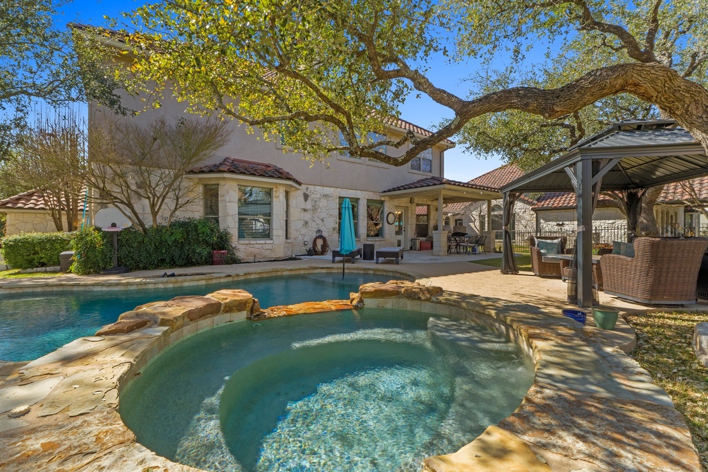 15104 Spillman Ranch Loop Austin, TX 78738 - Photo 28 of 31 a swimming pool with outdoor seating and yard
