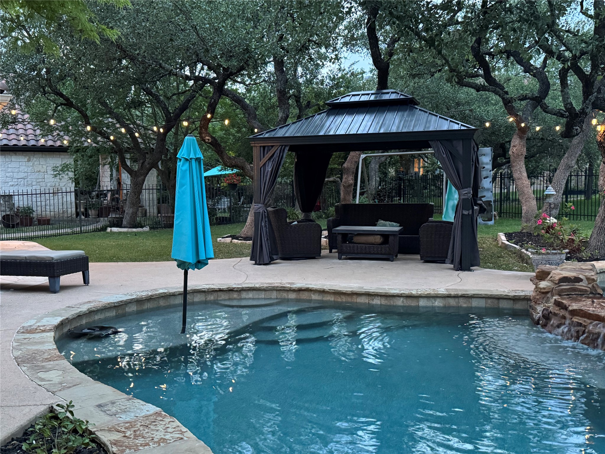 15104 Spillman Ranch Loop Austin, TX 78738 - Photo 30 of 31 a view of a house with a small yard and sitting area