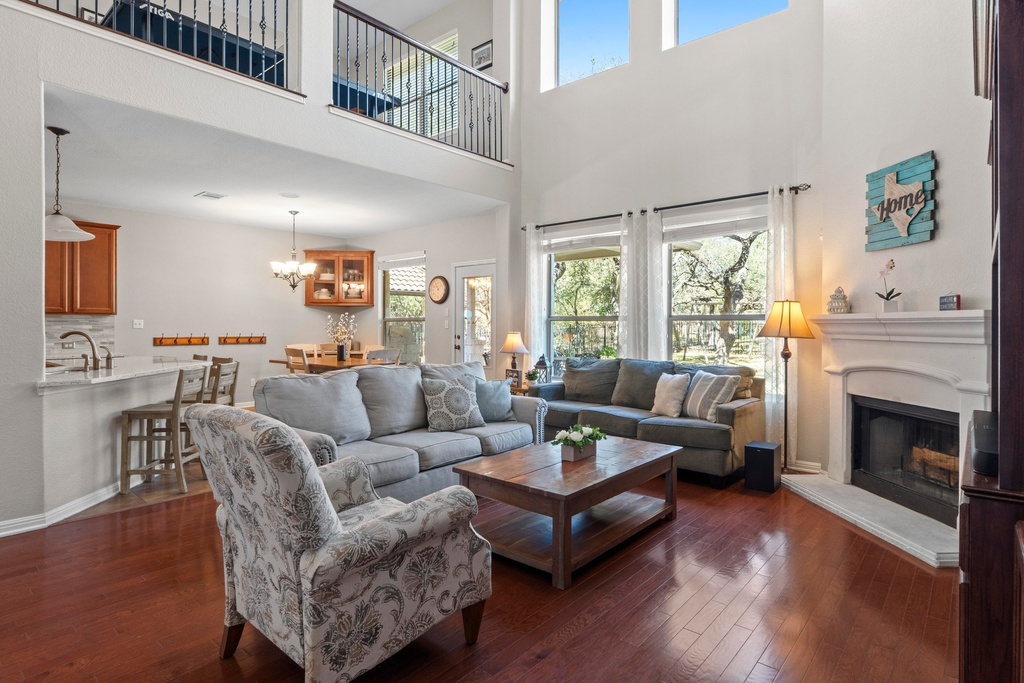 15104 Spillman Ranch Loop Austin, TX 78738 - Photo 3 of 31 a living room with furniture and a fireplace