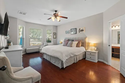 a spacious bedroom with a bed and a large window