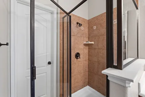 a bathroom with a shower and a sink