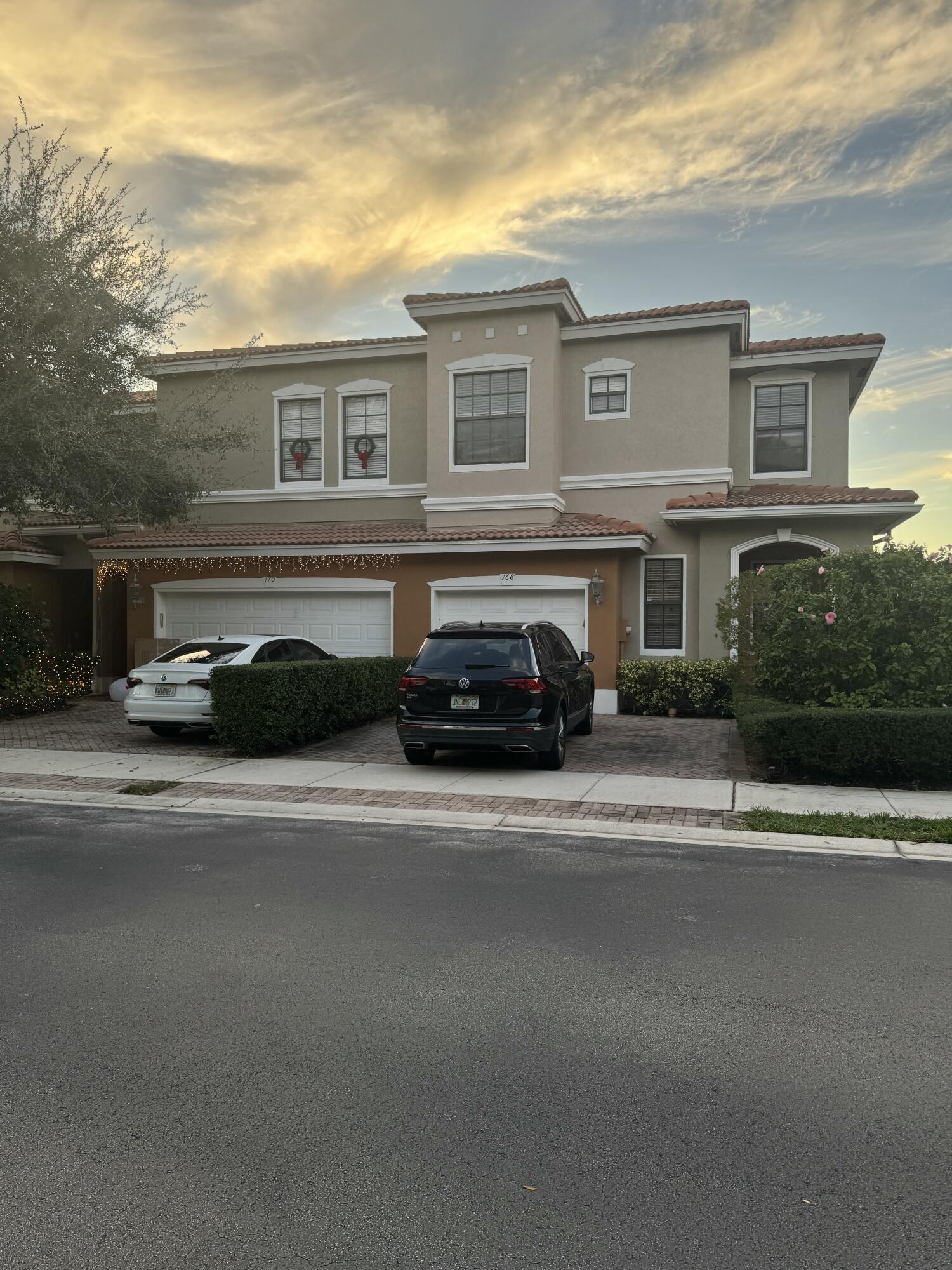 168 Astor Circle Delray Beach, FL 33484 - Photo 1 of 18 a view of a car parked in front of a building