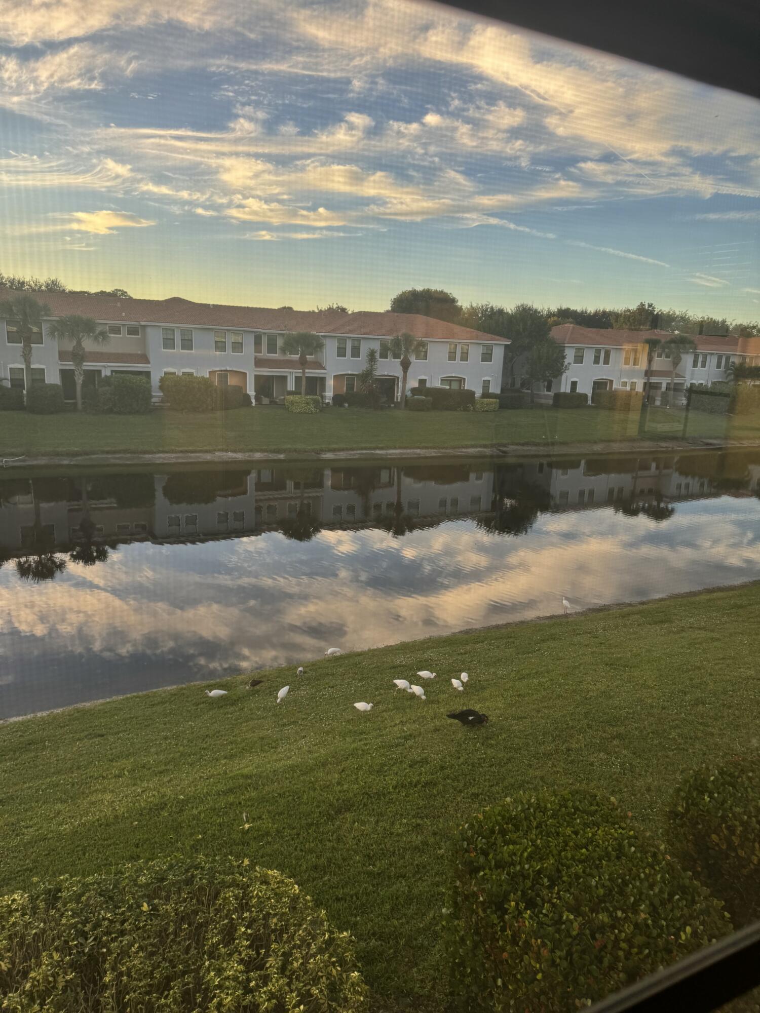 168 Astor Circle Delray Beach, FL 33484 - Photo 11 of 18 a view of a lake with houses in the background