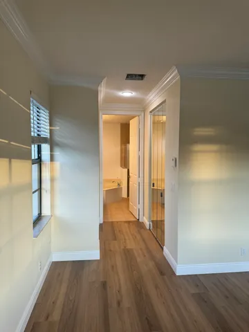 a view of hallway with wooden floor