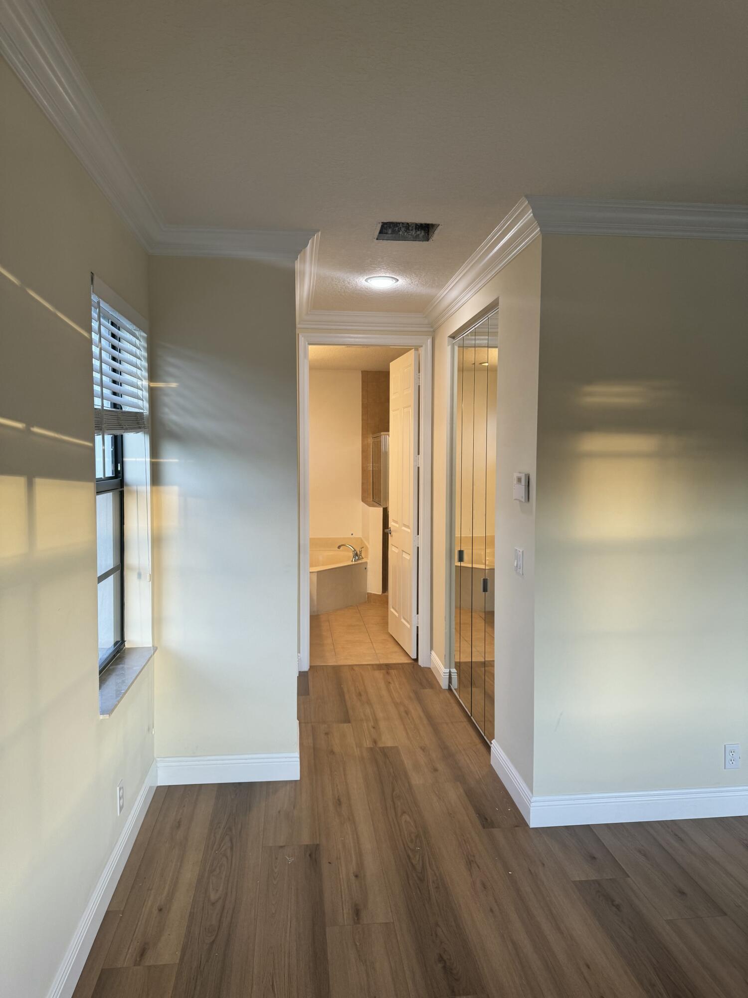 168 Astor Circle Delray Beach, FL 33484 - Photo 12 of 18 a view of hallway with wooden floor