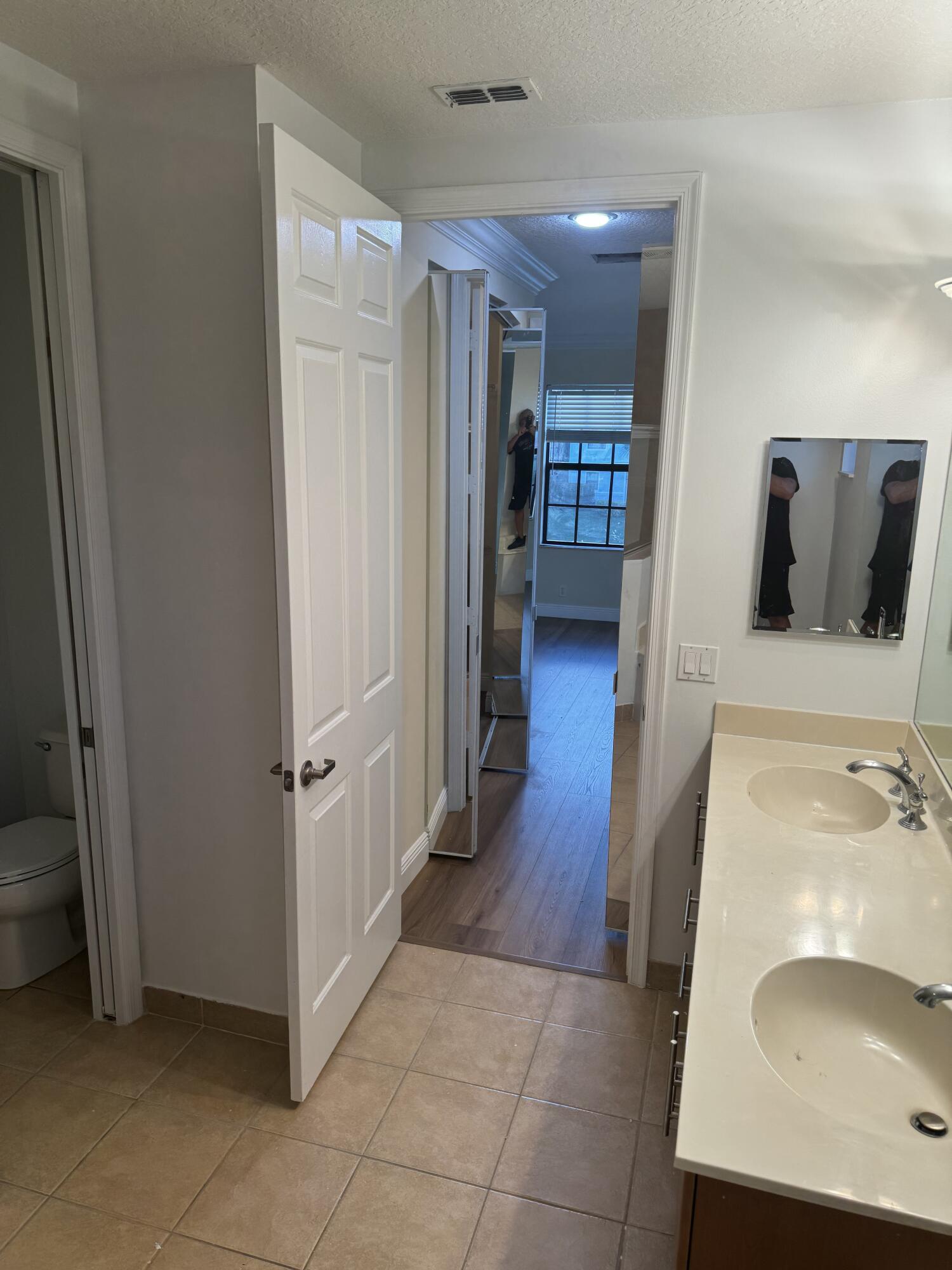 168 Astor Circle Delray Beach, FL 33484 - Photo 15 of 18 a bathroom with a sink and mirror