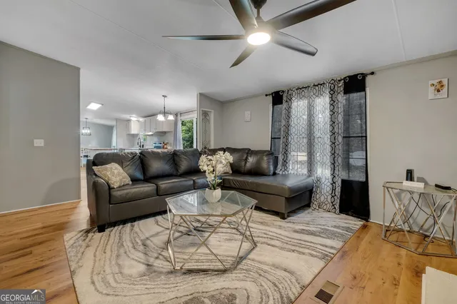 a living room with furniture and a chandelier