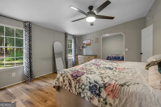a spacious bedroom with a large bed and a chandelier