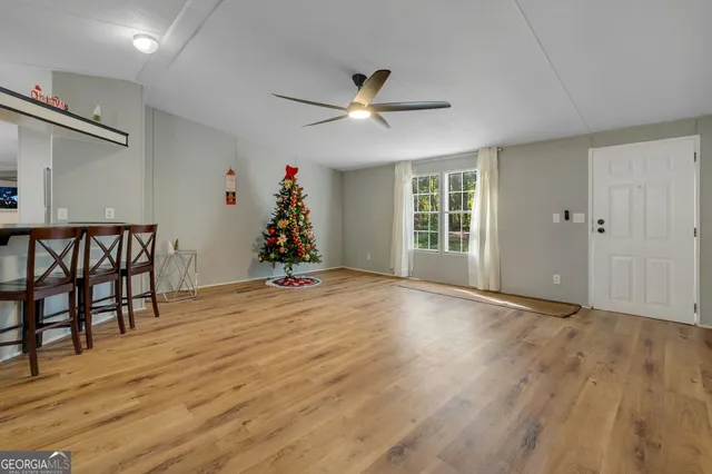 a view of livingroom with hardwood floor and a ceiling fan