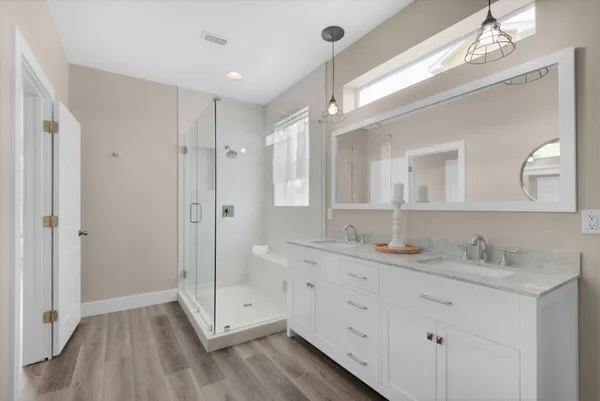 a bathroom with a granite countertop sink mirror and double