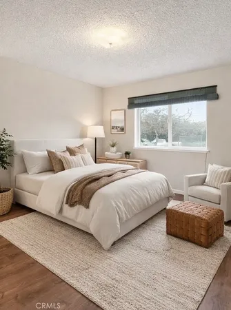 a bedroom with bed and a large window