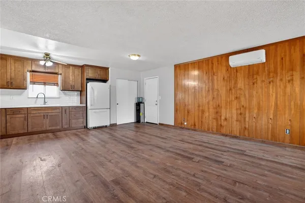 a view of a kitchen with wooden floor and a sink
