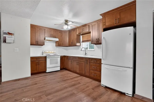 a kitchen with stainless steel appliances a refrigerator sink and cabinets