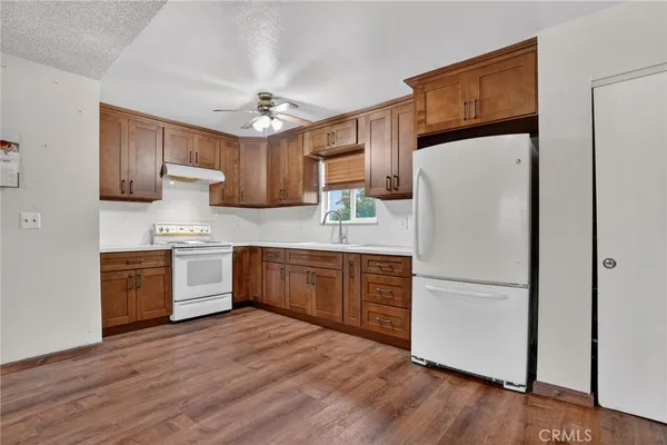 a kitchen with a refrigerator a sink and cabinets