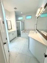 a bathroom with a sink double vanity and a mirror