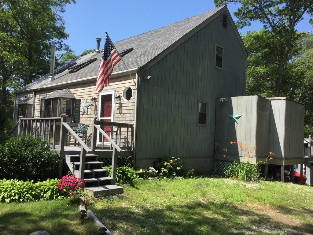 28 Deerfield Road Mashpee, MA 02649 - Photo 1 of 19 a view of backyard with deck and garden
