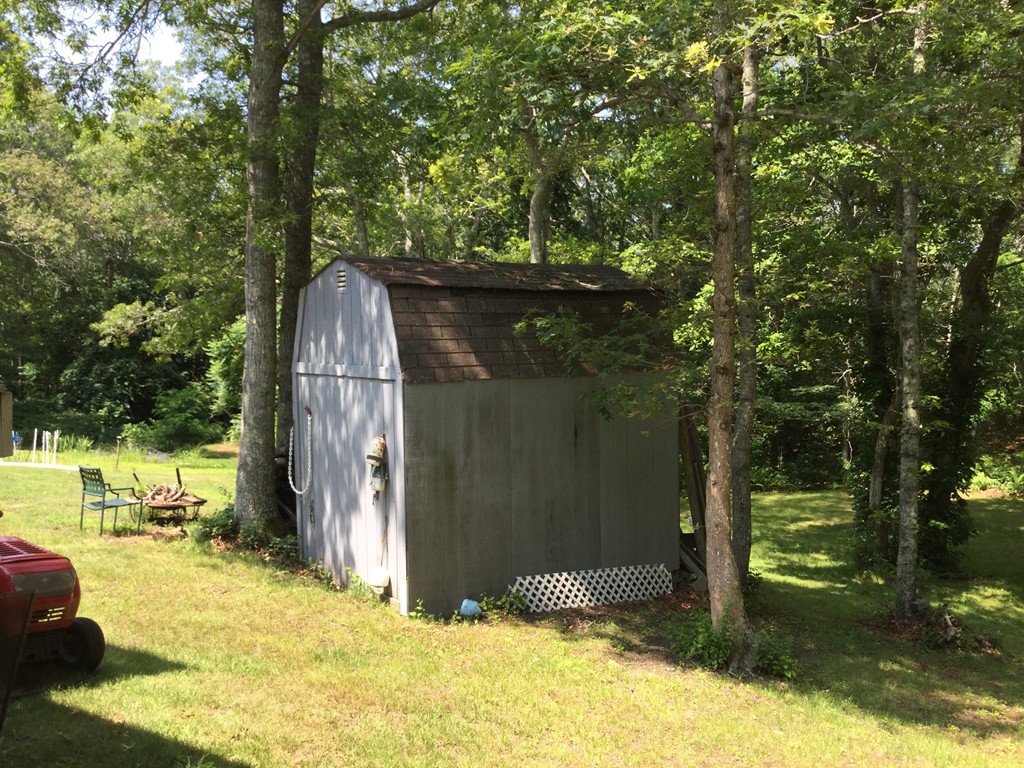 28 Deerfield Road Mashpee, MA 02649 - Photo 5 of 19 a backyard of a house with a yard and outdoor seating