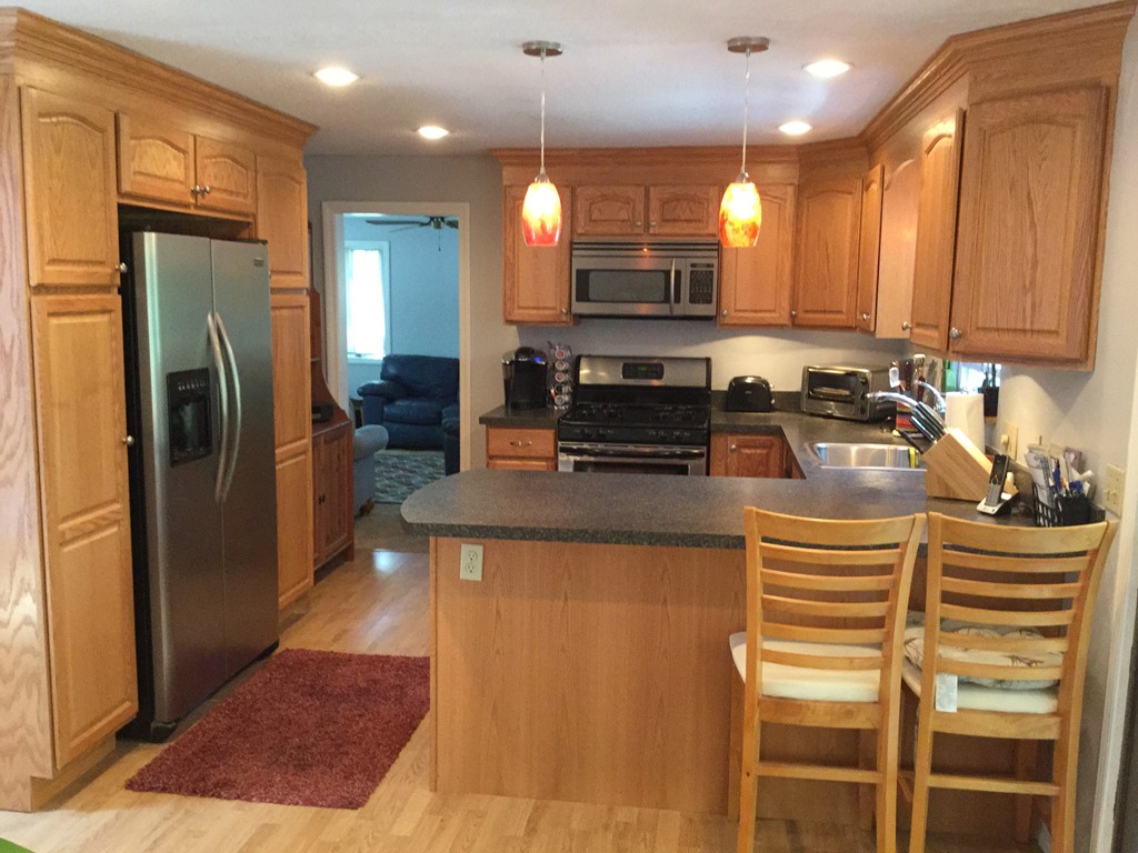 28 Deerfield Road Mashpee, MA 02649 - Photo 10 of 19 a kitchen with stainless steel appliances granite countertop a refrigerator a stove a sink and a microwave