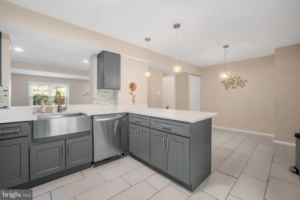 a kitchen with a sink window and cabinets