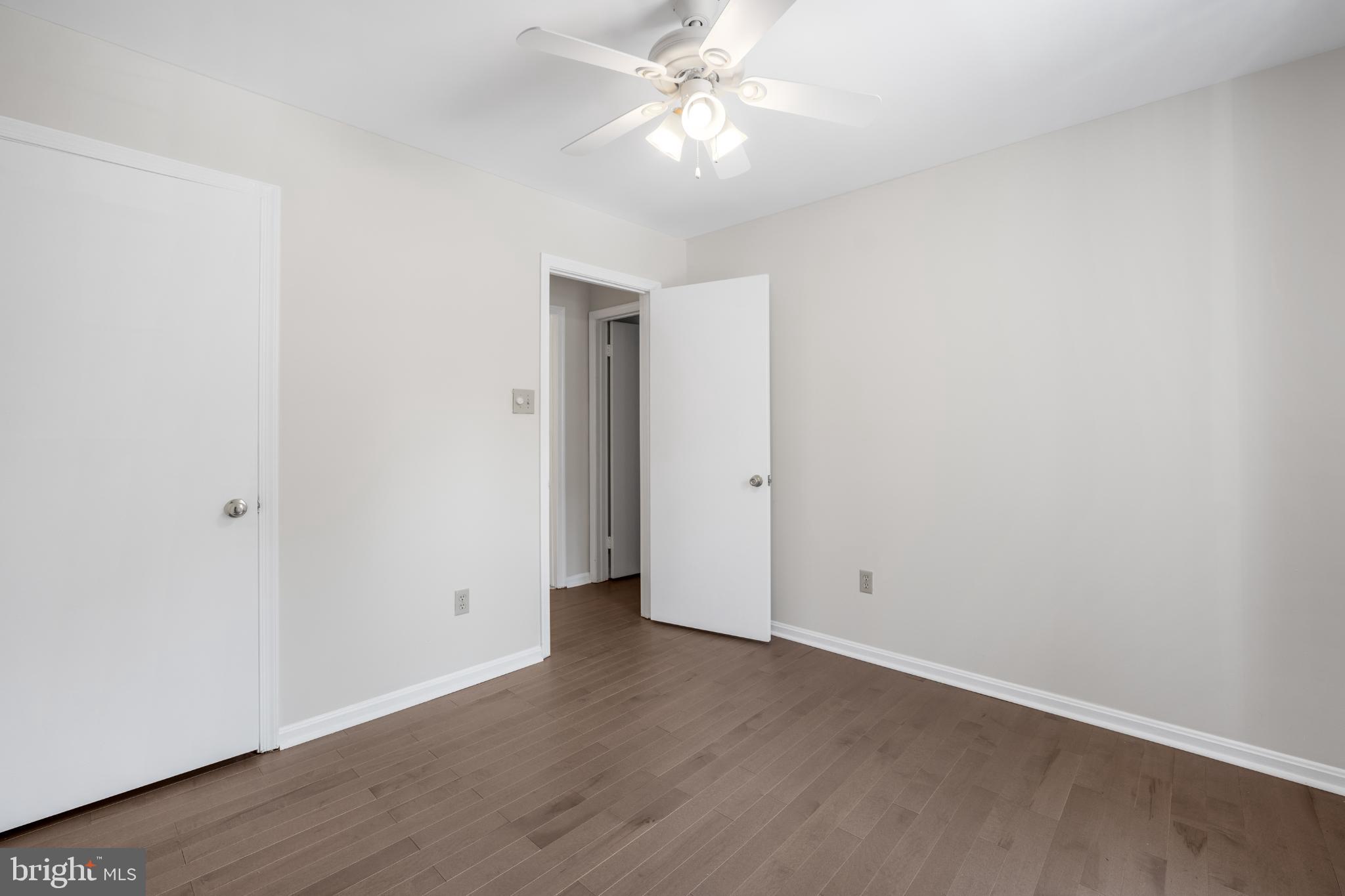 11521 Shell Flower Lane Columbia, MD 21044 - Photo 19 of 31 an empty room with wooden floor and fan