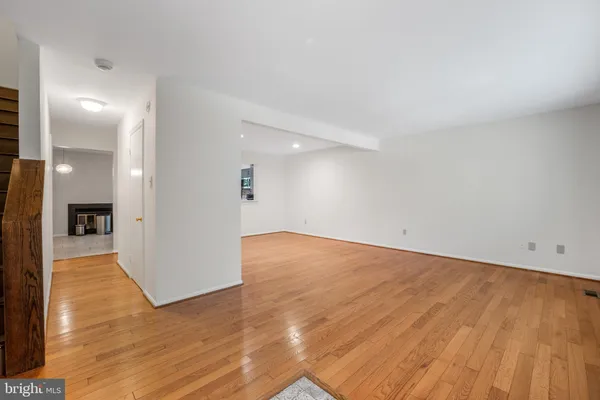 a view of a big room with wooden floor and a bathroom