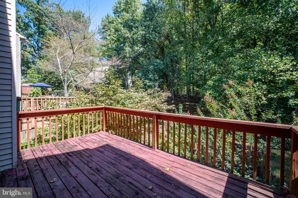 a view of balcony with wooden floor and fence