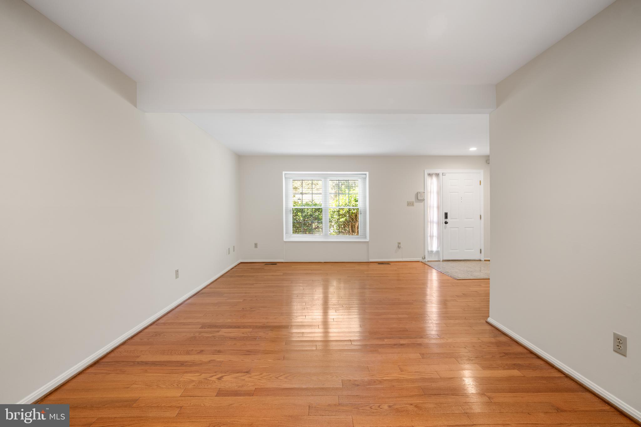 11521 Shell Flower Lane Columbia, MD 21044 - Photo 5 of 31 an empty room with wooden floor and windows