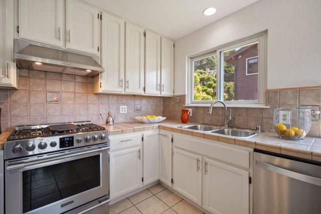 a view of kitchen with a sink and a mirror