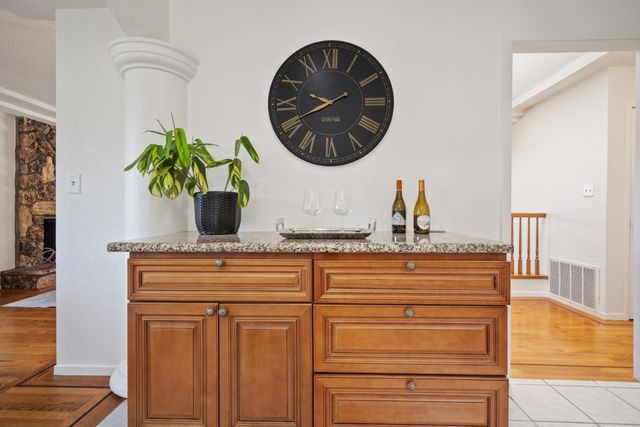 a bathroom with a granite countertop toilet sink and mirror