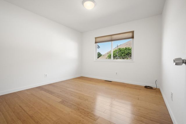 a bedroom with bed and a chandelier