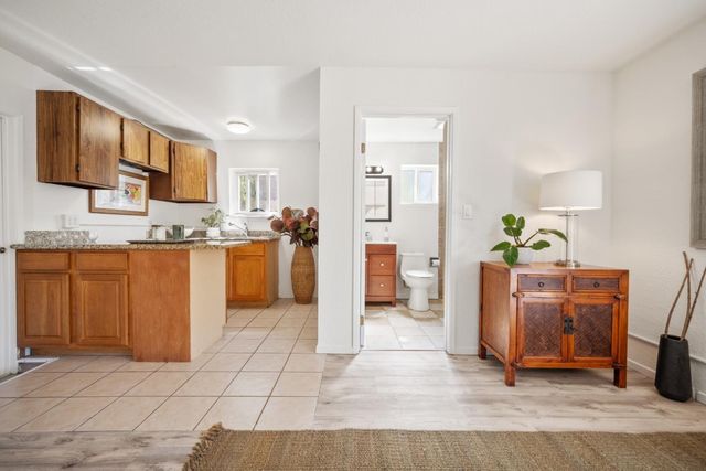 a bathroom with a granite countertop sink a mirror and a shower
