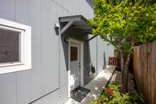 a view of a house with backyard and sitting area