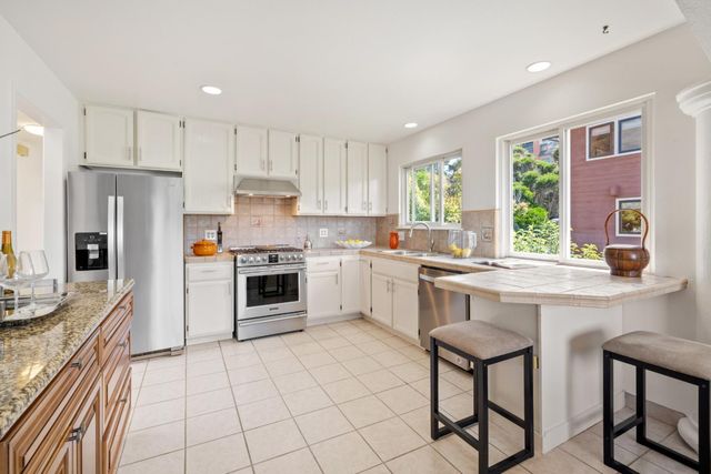 a kitchen with a sink stove and cabinets