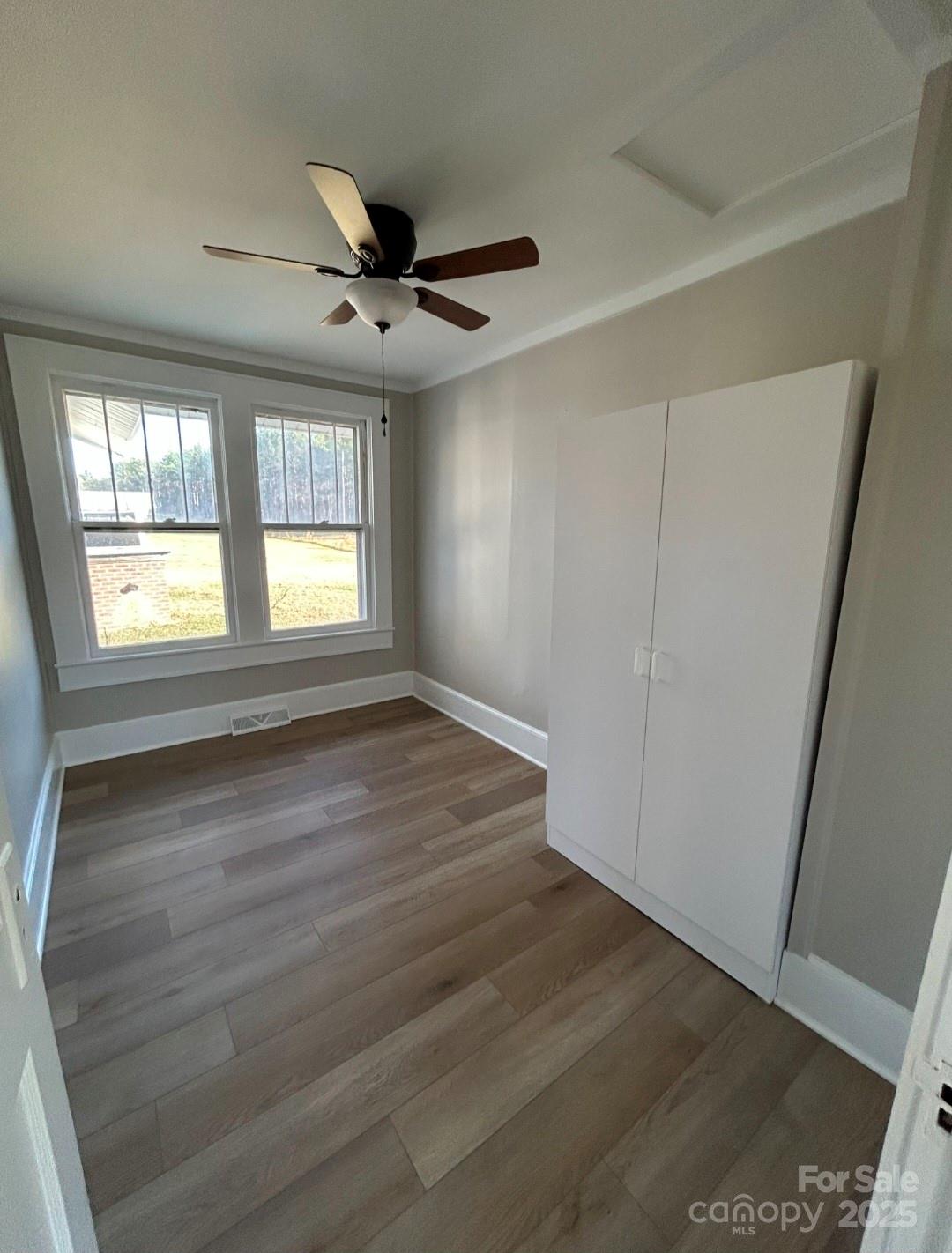 36040 Palestine Road Albemarle, NC 28001 - Photo 19 of 43 an empty room with wooden floor and windows
