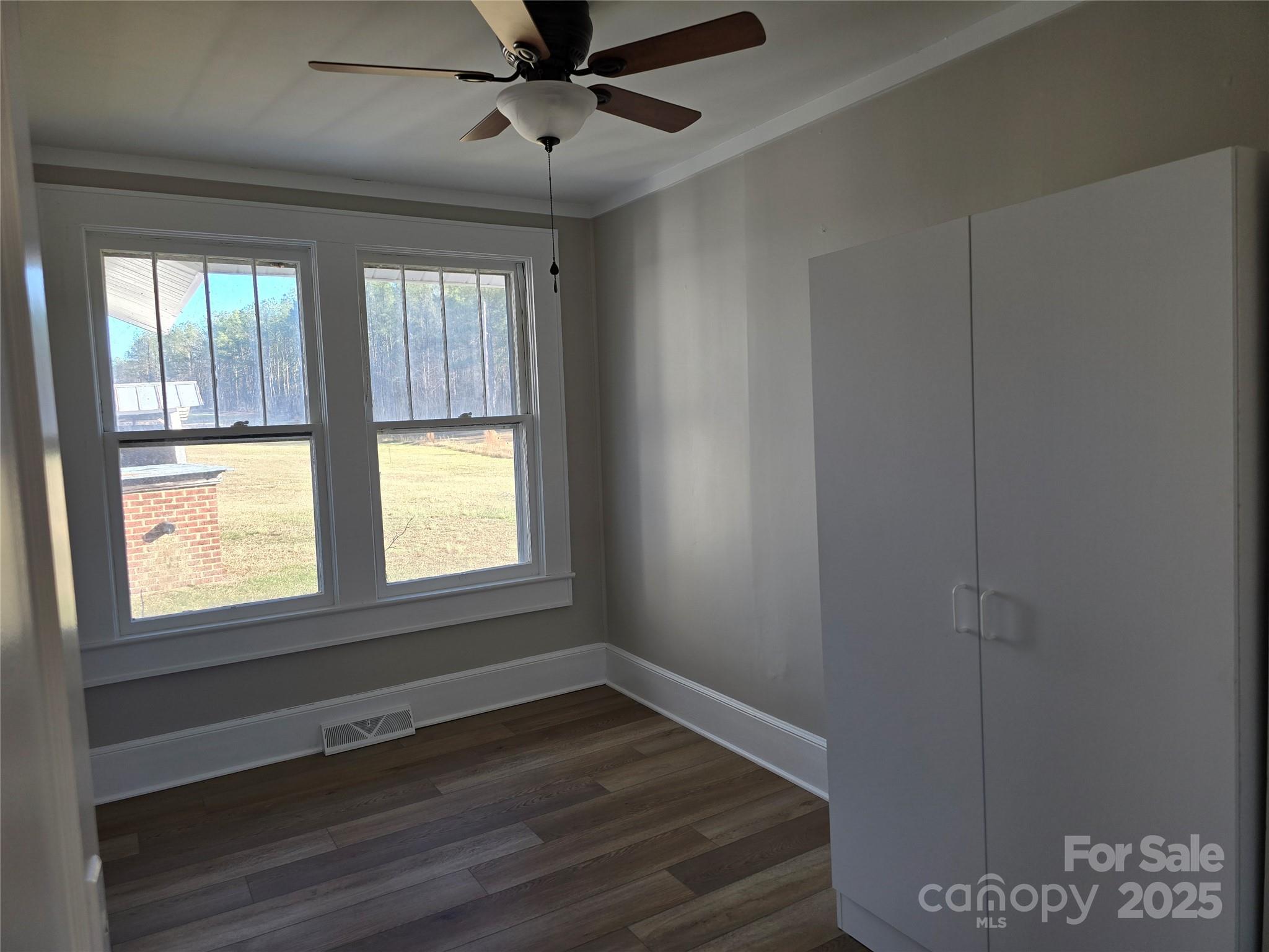 36040 Palestine Road Albemarle, NC 28001 - Photo 20 of 43 a view of an empty room with a window and wooden floor