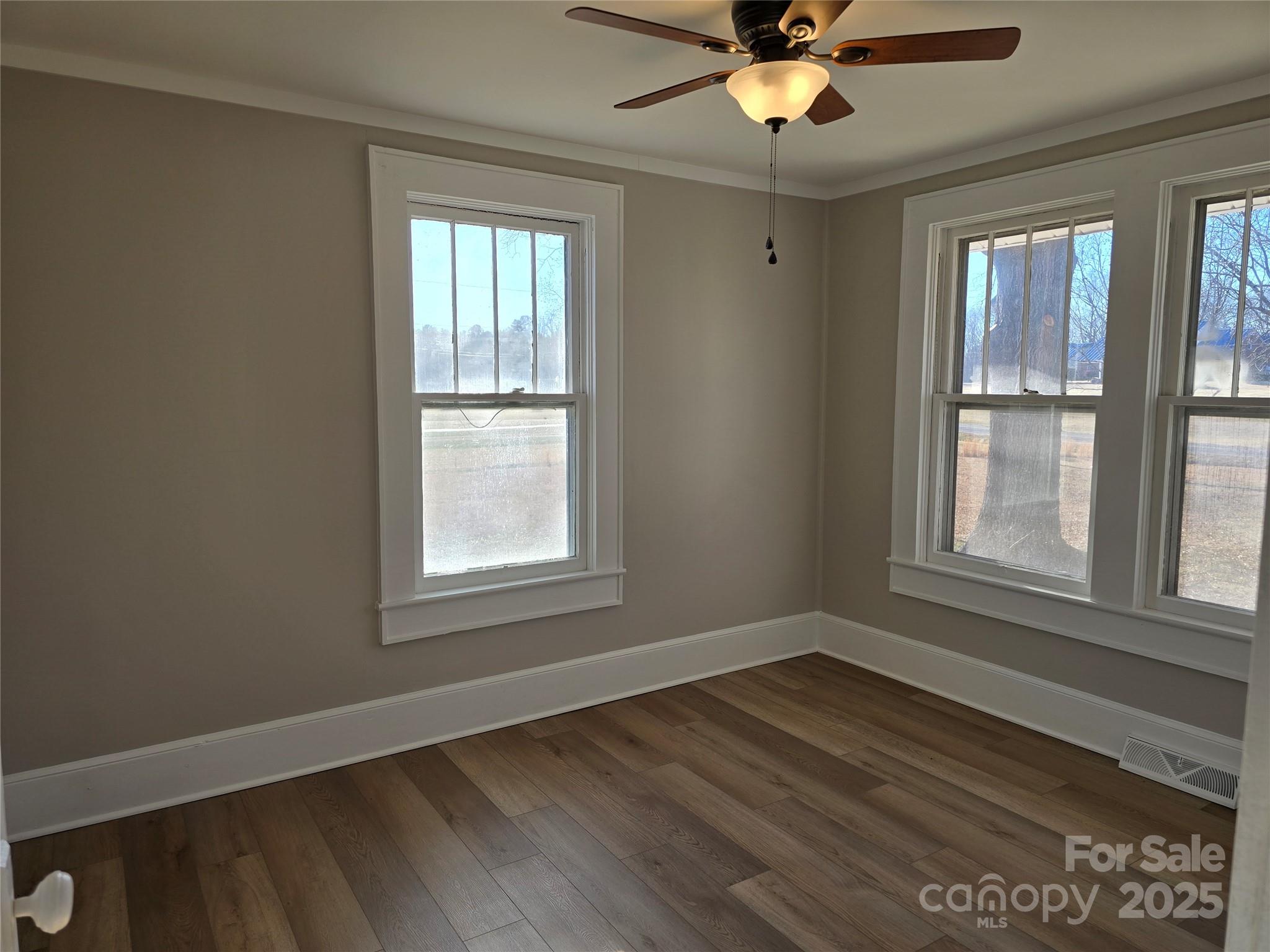 36040 Palestine Road Albemarle, NC 28001 - Photo 25 of 43 a view of an empty room with wooden floor and a window