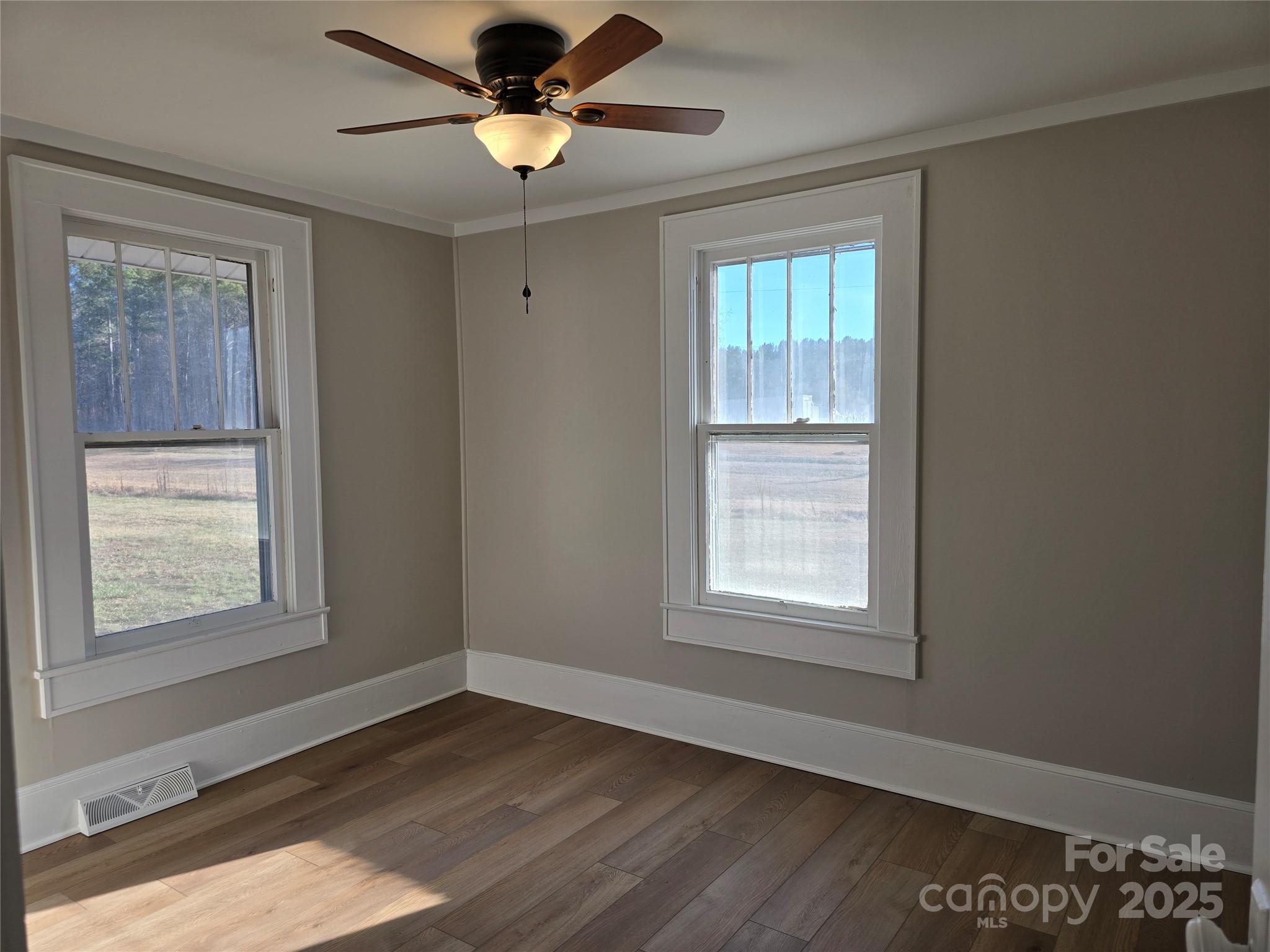 36040 Palestine Road Albemarle, NC 28001 - Photo 27 of 43 a view of an empty room with wooden floor and a window