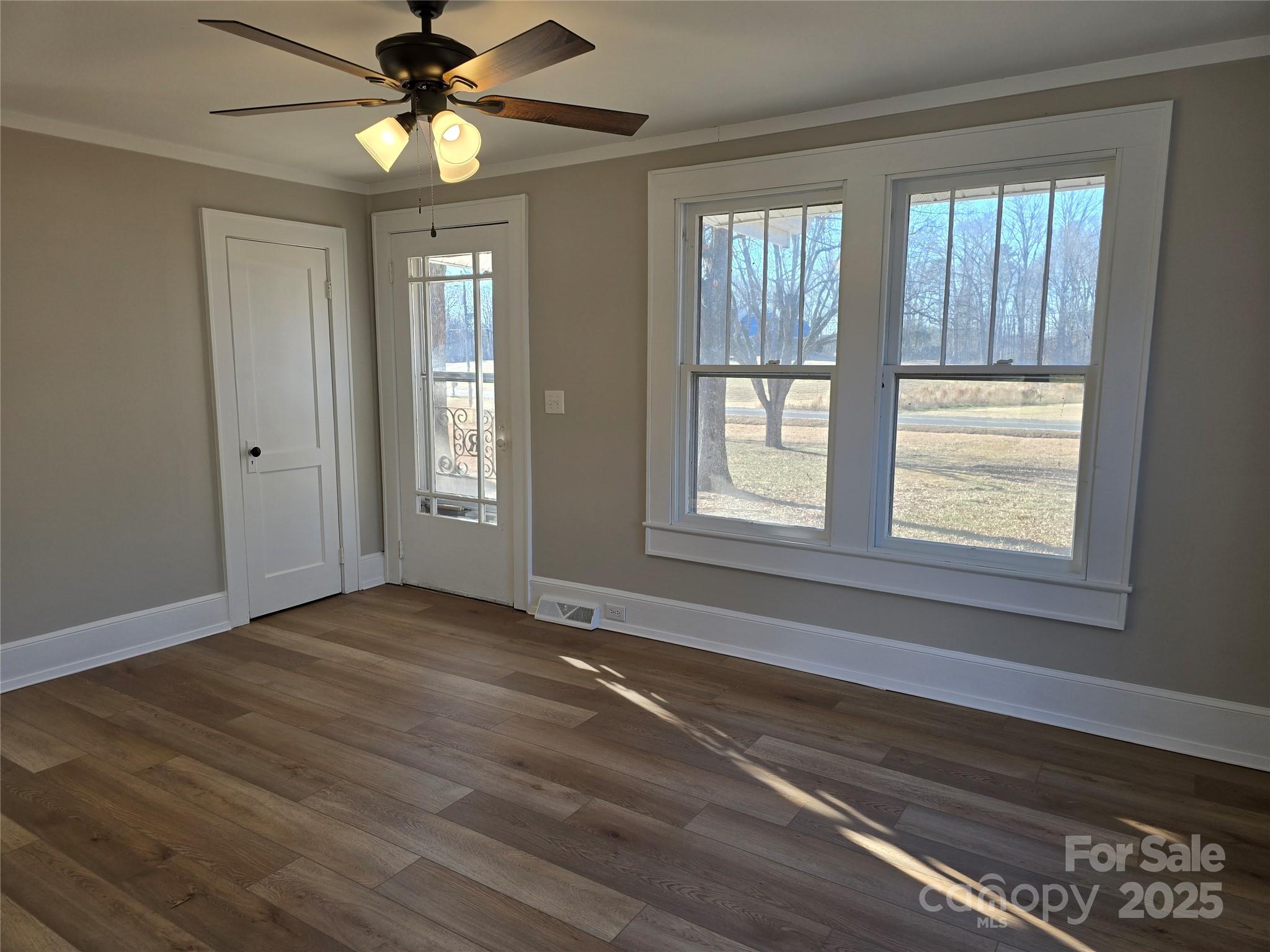 36040 Palestine Road Albemarle, NC 28001 - Photo 5 of 43 a view of an empty room with a window and wooden floor