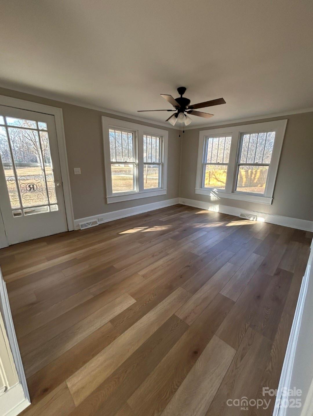 36040 Palestine Road Albemarle, NC 28001 - Photo 7 of 43 a view of an empty room with a window and wooden floor