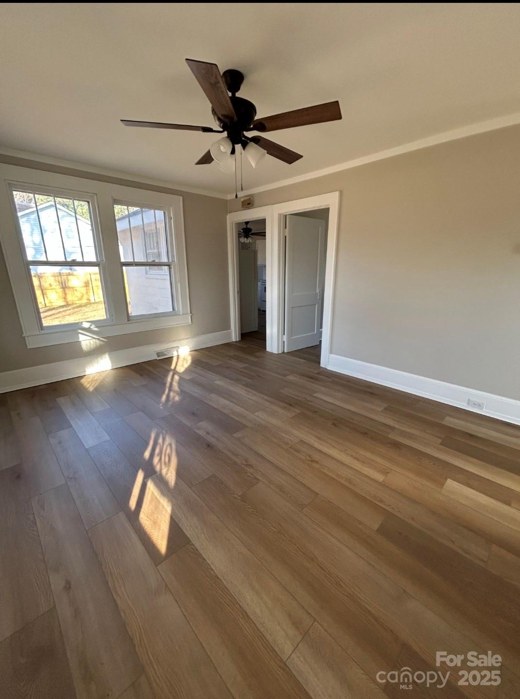 36040 Palestine Road Albemarle, NC 28001 - Photo 8 of 43 an empty room with wooden floor and windows