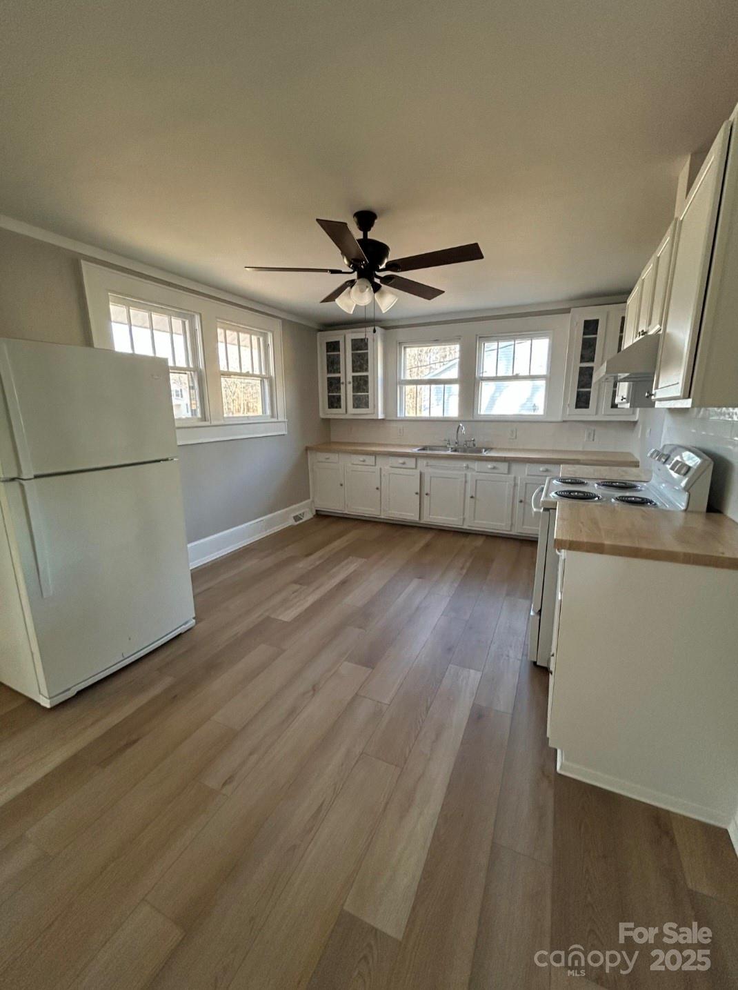 36040 Palestine Road Albemarle, NC 28001 - Photo 10 of 43 a view of a livingroom with furniture a ceiling fan and wooden floor
