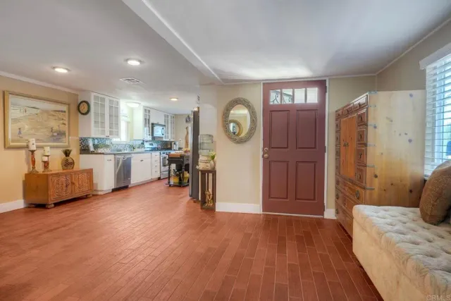 a view of a living room kitchen and a wooden floor