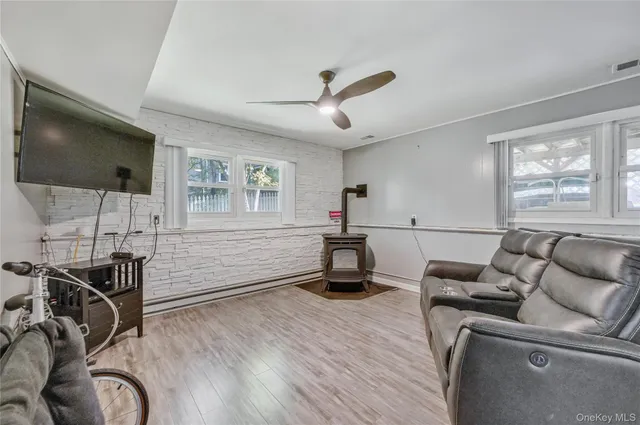 a living room with furniture gym equipment and a flat screen tv