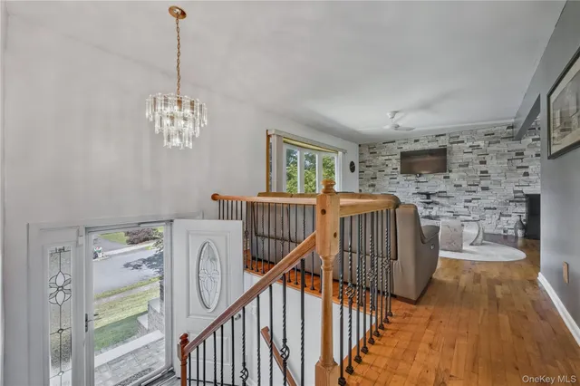 a view of a room with wooden floor windows and a chandelier